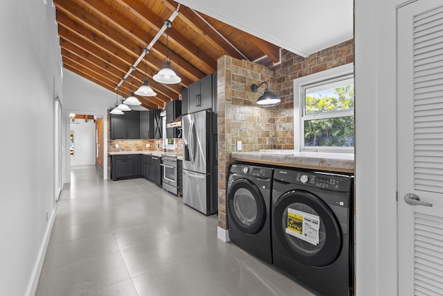 washroom featuring separate washer and dryer, wood ceiling, and baseboards