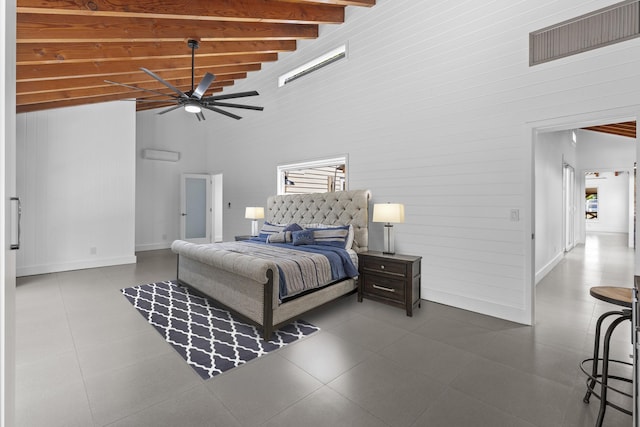 bedroom with a towering ceiling, beamed ceiling, baseboards, wood walls, and a ceiling fan
