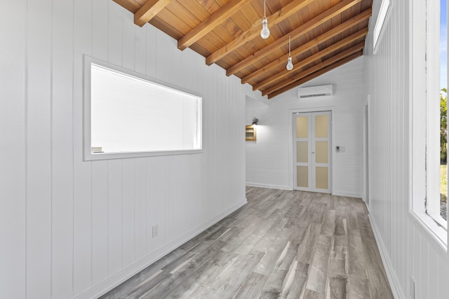 unfurnished room with wood ceiling, a wall unit AC, french doors, and wood finished floors
