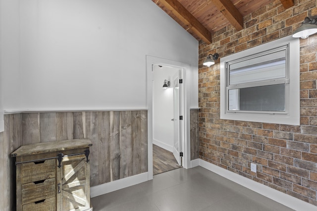 hall with wooden ceiling, beamed ceiling, and wainscoting