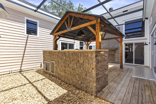 view of patio / terrace featuring a gazebo, ceiling fan, and a deck
