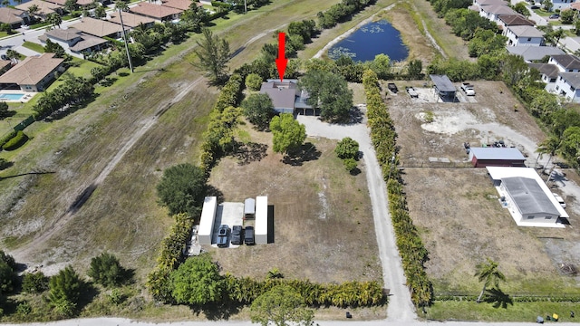 view of property location with a nearby body of water and nearby suburban area
