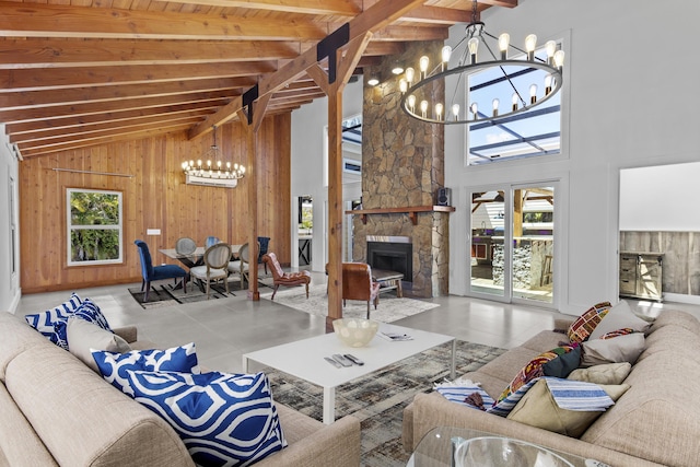 living room with a chandelier, wooden walls, beam ceiling, high vaulted ceiling, and a fireplace