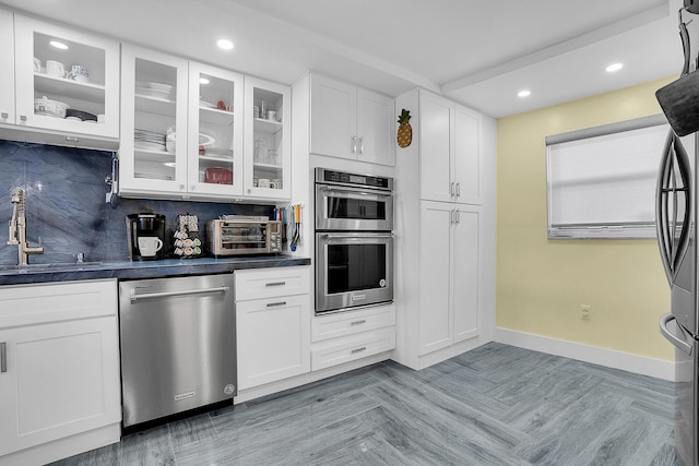 1537 E Hillsboro Blvd Unit 341, Deerfield Beach, FL 33441 - kitchen featuring stainless steel appliances, a sink, recessed lighting, dark countertops, and white cabinets