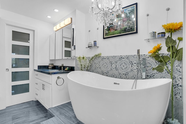 1537 E Hillsboro Blvd Unit 341, Deerfield Beach, FL 33441 - bathroom with vanity, a freestanding tub, a chandelier, recessed lighting, and wood finished floors