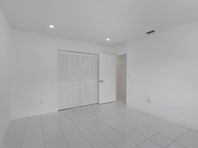 1138 SW Gardena Ave, Port Saint Lucie, FL 34953 - unfurnished bedroom with recessed lighting, a closet, baseboards, and light tile patterned floors