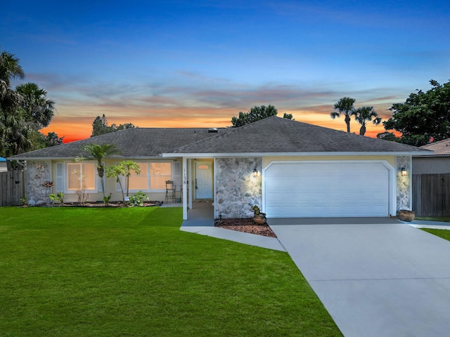 1138 SW Gardena Ave, Port Saint Lucie, FL 34953 - ranch-style home with stone siding, a garage, concrete driveway, and a shingled roof