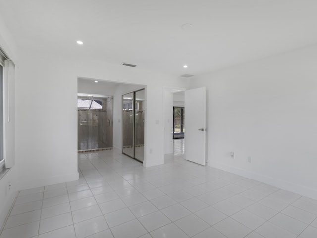 1138 SW Gardena Ave, Port Saint Lucie, FL 34953 - unfurnished room with recessed lighting, healthy amount of natural light, baseboards, and light tile patterned floors
