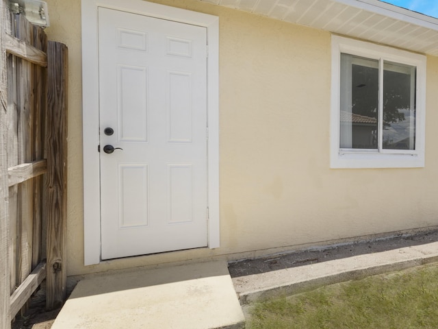 1138 SW Gardena Ave, Port Saint Lucie, FL 34953 - doorway to property with stucco siding