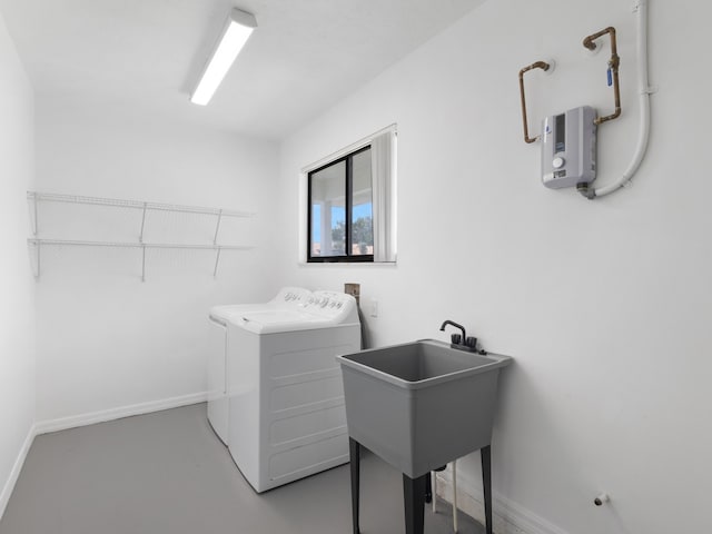 1138 SW Gardena Ave, Port Saint Lucie, FL 34953 - washroom with washing machine and clothes dryer and baseboards