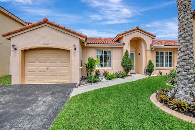 1266 NW 126th Ter, Sunrise, FL 33323 - mediterranean / spanish home featuring an attached garage, driveway, a front lawn, and stucco siding