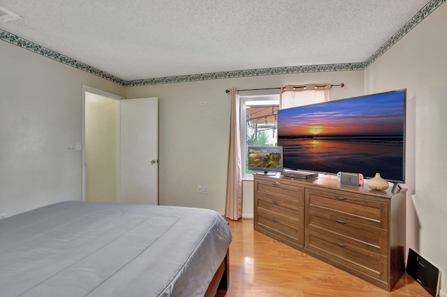 1266 NW 126th Ter, Sunrise, FL 33323 - bedroom with a textured ceiling and light wood finished floors