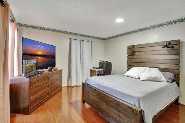 1266 NW 126th Ter, Sunrise, FL 33323 - bedroom with a textured ceiling, light wood-style floors, recessed lighting, and an office area