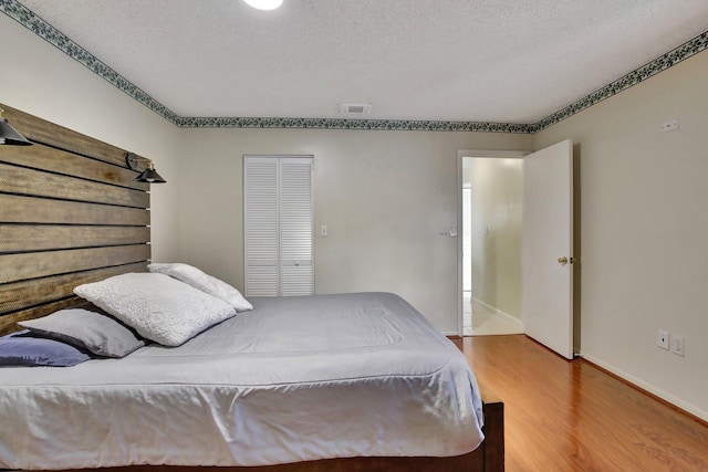 1266 NW 126th Ter, Sunrise, FL 33323 - bedroom featuring wood finished floors, a closet, and baseboards
