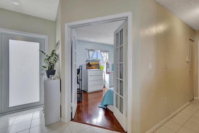 1266 NW 126th Ter, Sunrise, FL 33323 - foyer entrance with a textured ceiling, baseboards, and tile patterned floors