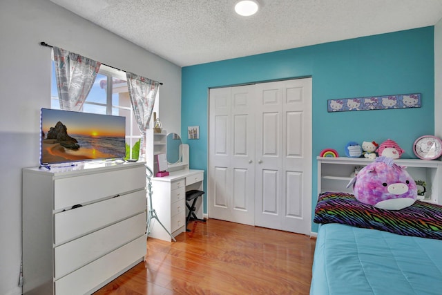 1266 NW 126th Ter, Sunrise, FL 33323 - bedroom featuring a closet, light wood-style flooring, and a textured ceiling