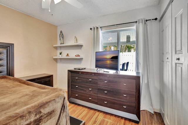 1266 NW 126th Ter, Sunrise, FL 33323 - bedroom with light wood-style floors, baseboards, ceiling fan, and a textured ceiling