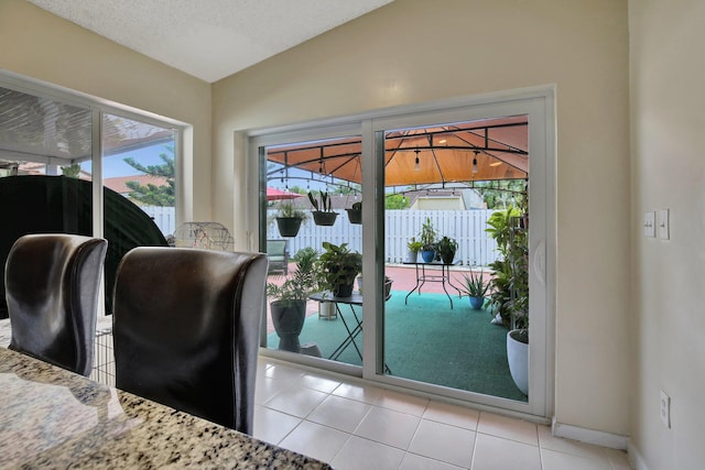 1266 NW 126th Ter, Sunrise, FL 33323 - doorway with vaulted ceiling, baseboards, and tile patterned flooring