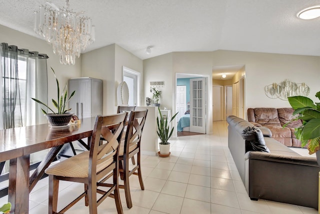 1266 NW 126th Ter, Sunrise, FL 33323 - dining area featuring lofted ceiling, a textured ceiling, a chandelier, light tile patterned flooring, and baseboards
