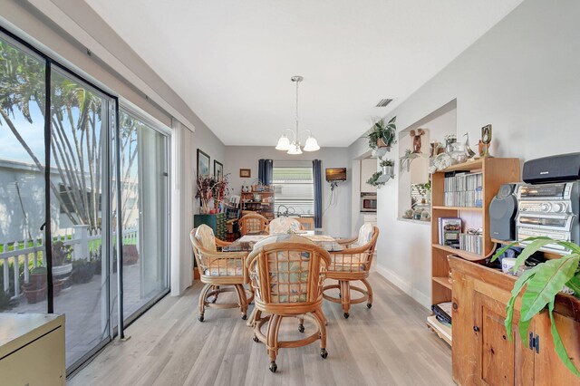 2115 SW 22nd St, Boynton Beach, FL 33426 - dining room with a chandelier, wood finished floors, and baseboards