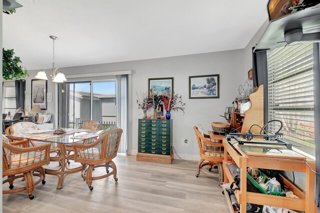 2115 SW 22nd St, Boynton Beach, FL 33426 - dining room featuring light wood-style flooring, a chandelier, and baseboards