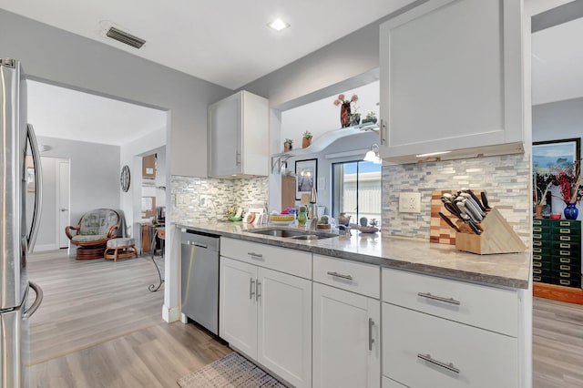 2115 SW 22nd St, Boynton Beach, FL 33426 - kitchen featuring stainless steel appliances, light wood-style floors, and light stone counters