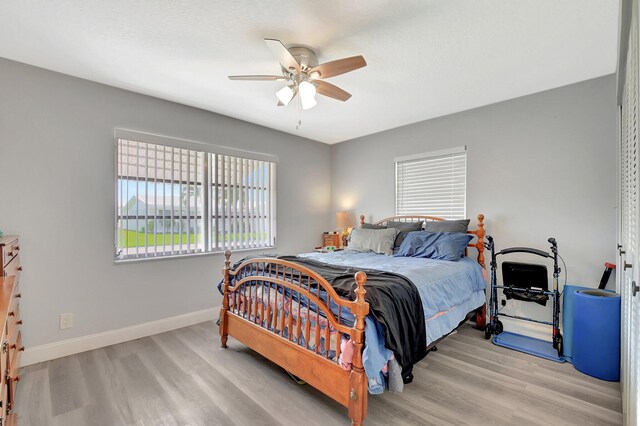 2115 SW 22nd St, Boynton Beach, FL 33426 - bedroom featuring wood finished floors, baseboards, and a ceiling fan