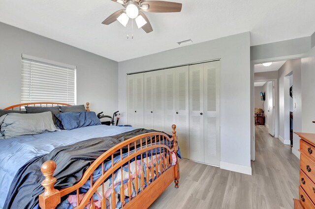 2115 SW 22nd St, Boynton Beach, FL 33426 - bedroom with light wood-style flooring, a closet, baseboards, and a ceiling fan