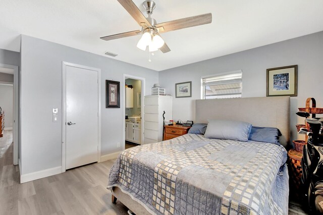 2115 SW 22nd St, Boynton Beach, FL 33426 - bedroom featuring light wood-type flooring, baseboards, ceiling fan, and ensuite bathroom