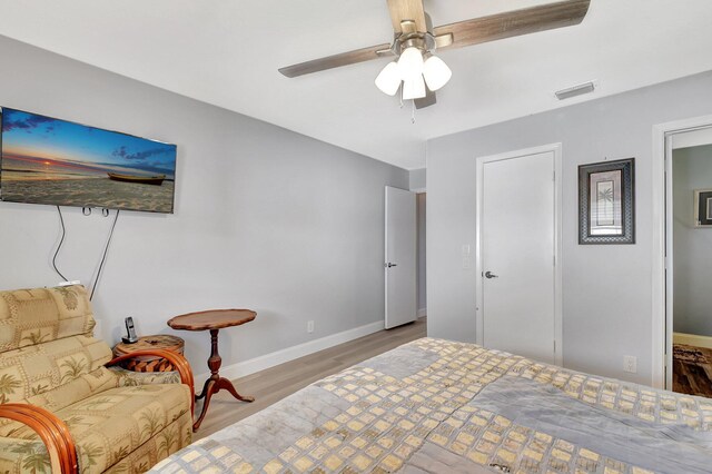 2115 SW 22nd St, Boynton Beach, FL 33426 - bedroom with wood finished floors, baseboards, and ceiling fan