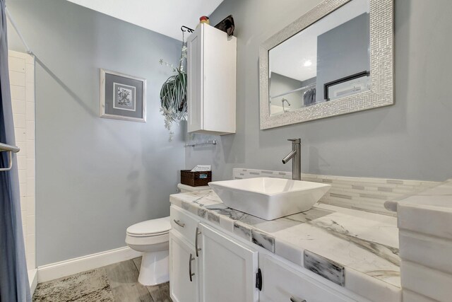 2115 SW 22nd St, Boynton Beach, FL 33426 - bathroom featuring toilet, vanity, a shower, and baseboards