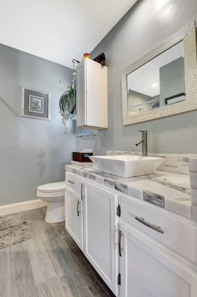 2115 SW 22nd St, Boynton Beach, FL 33426 - bathroom with toilet, vanity, wood finished floors, and baseboards