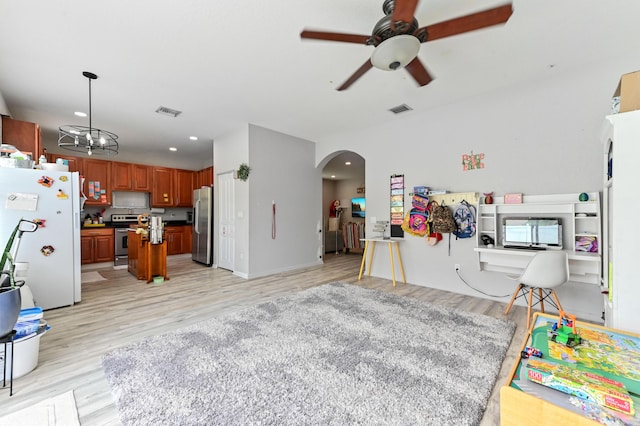 561 Peppergrass Run, Royal Palm Beach, FL 33411 - kitchen featuring appliances with stainless steel finishes, open floor plan, arched walkways, light wood-style floors, and a ceiling fan