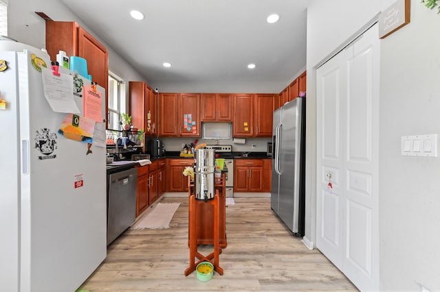 561 Peppergrass Run, Royal Palm Beach, FL 33411 - kitchen featuring stainless steel appliances, dark countertops, recessed lighting, light wood finished floors, and a center island