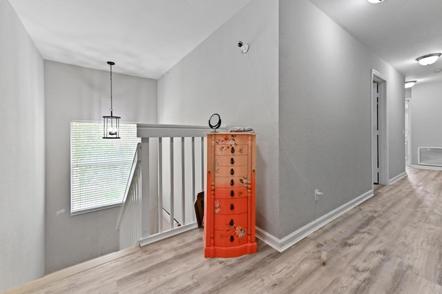 561 Peppergrass Run, Royal Palm Beach, FL 33411 - hall with wood finished floors, an upstairs landing, and baseboards