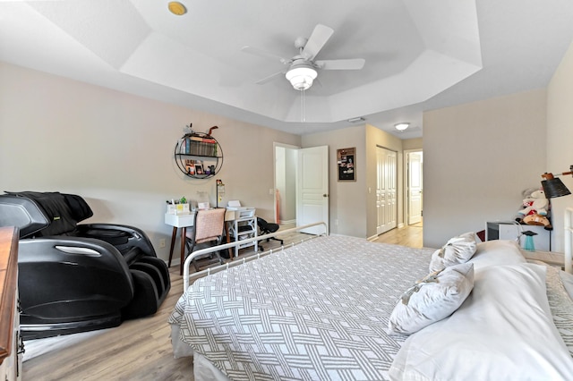 561 Peppergrass Run, Royal Palm Beach, FL 33411 - bedroom with a tray ceiling, light wood finished floors, a closet, and ceiling fan