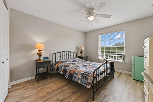 561 Peppergrass Run, Royal Palm Beach, FL 33411 - bedroom featuring freestanding refrigerator, light wood-style flooring, baseboards, and a ceiling fan
