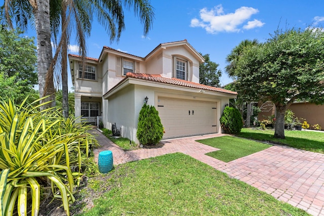 561 Peppergrass Run, Royal Palm Beach, FL 33411 - mediterranean / spanish-style home with stucco siding, a tile roof, a front yard, and a garage