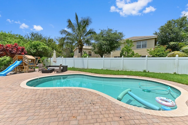 561 Peppergrass Run, Royal Palm Beach, FL 33411 - view of pool featuring a patio, an outdoor living space, and a playground