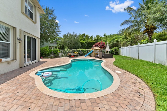 561 Peppergrass Run, Royal Palm Beach, FL 33411 - view of swimming pool with a fenced backyard, a patio area, and a playground