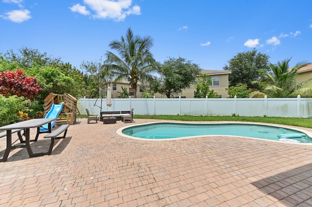 561 Peppergrass Run, Royal Palm Beach, FL 33411 - view of swimming pool with a patio, a fenced backyard, and an outdoor hangout area