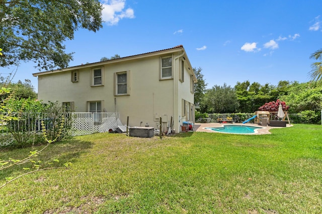 561 Peppergrass Run, Royal Palm Beach, FL 33411 - back of property with stucco siding and a lawn
