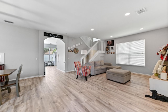 561 Peppergrass Run, Royal Palm Beach, FL 33411 - living area featuring stairs, light wood-style floors, arched walkways, recessed lighting, and baseboards