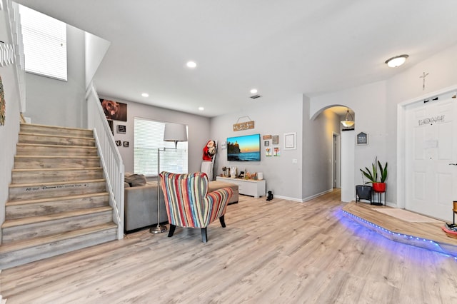 561 Peppergrass Run, Royal Palm Beach, FL 33411 - living room featuring arched walkways, light wood-style floors, stairway, recessed lighting, and baseboards
