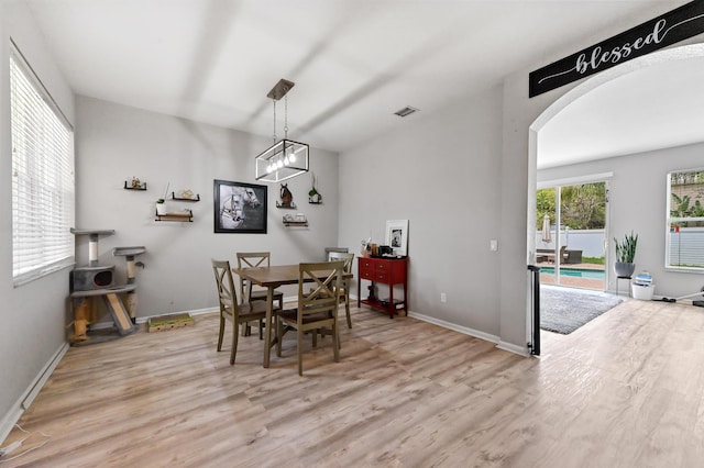 561 Peppergrass Run, Royal Palm Beach, FL 33411 - dining space featuring arched walkways, light wood-style floors, and baseboards
