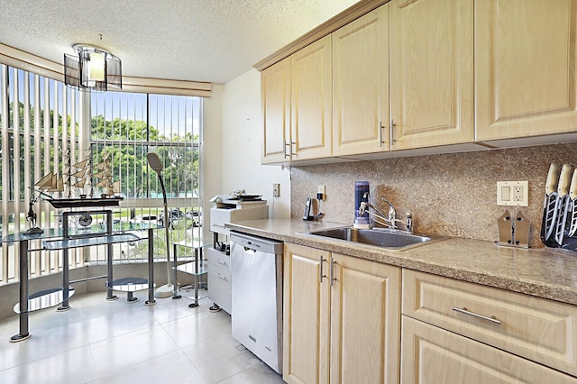 5936 Morningstar Cir Unit 201, Delray Beach, FL 33484 - kitchen featuring stainless steel dishwasher, a sink, light brown cabinets, decorative backsplash, and a textured ceiling