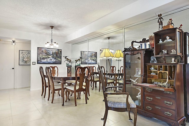 5936 Morningstar Cir Unit 201, Delray Beach, FL 33484 - dining area with a chandelier, a textured ceiling, and tile patterned flooring