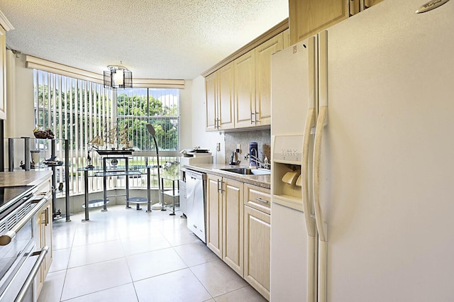 5936 Morningstar Cir Unit 201, Delray Beach, FL 33484 - kitchen with appliances with stainless steel finishes, a sink, expansive windows, tasteful backsplash, and light tile patterned flooring