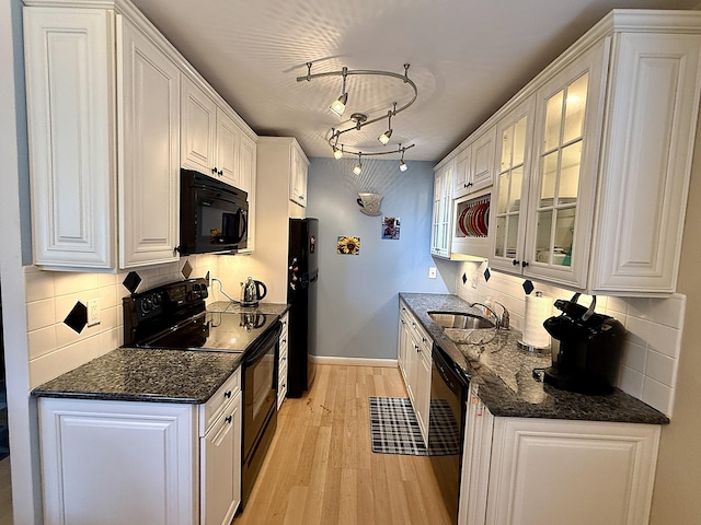 2060 Newport N, Deerfield Beach, FL 33442 - kitchen featuring black appliances, a sink, white cabinetry, light wood finished floors, and backsplash