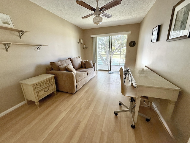 2060 Newport N, Deerfield Beach, FL 33442 - home office featuring ceiling fan, light wood finished floors, and a textured ceiling